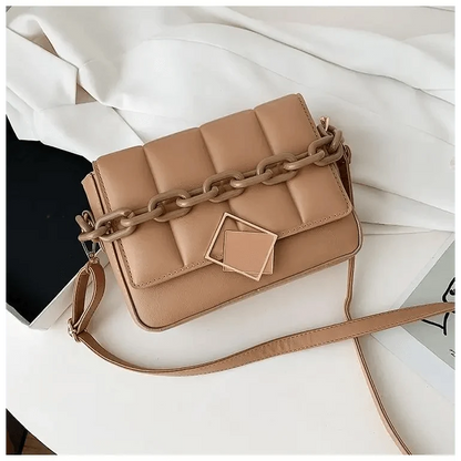 Tan quilted shoulder bag with chunky chain and square geometric clasp, crossbody style on Tampa Home & Garden Store