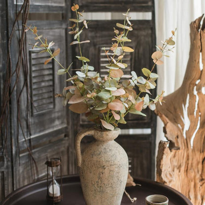Faux Leaf Autumn Eucalyptus Artificial Stem in ceramic vase with green and brown hues on Tampa Home & Garden Store