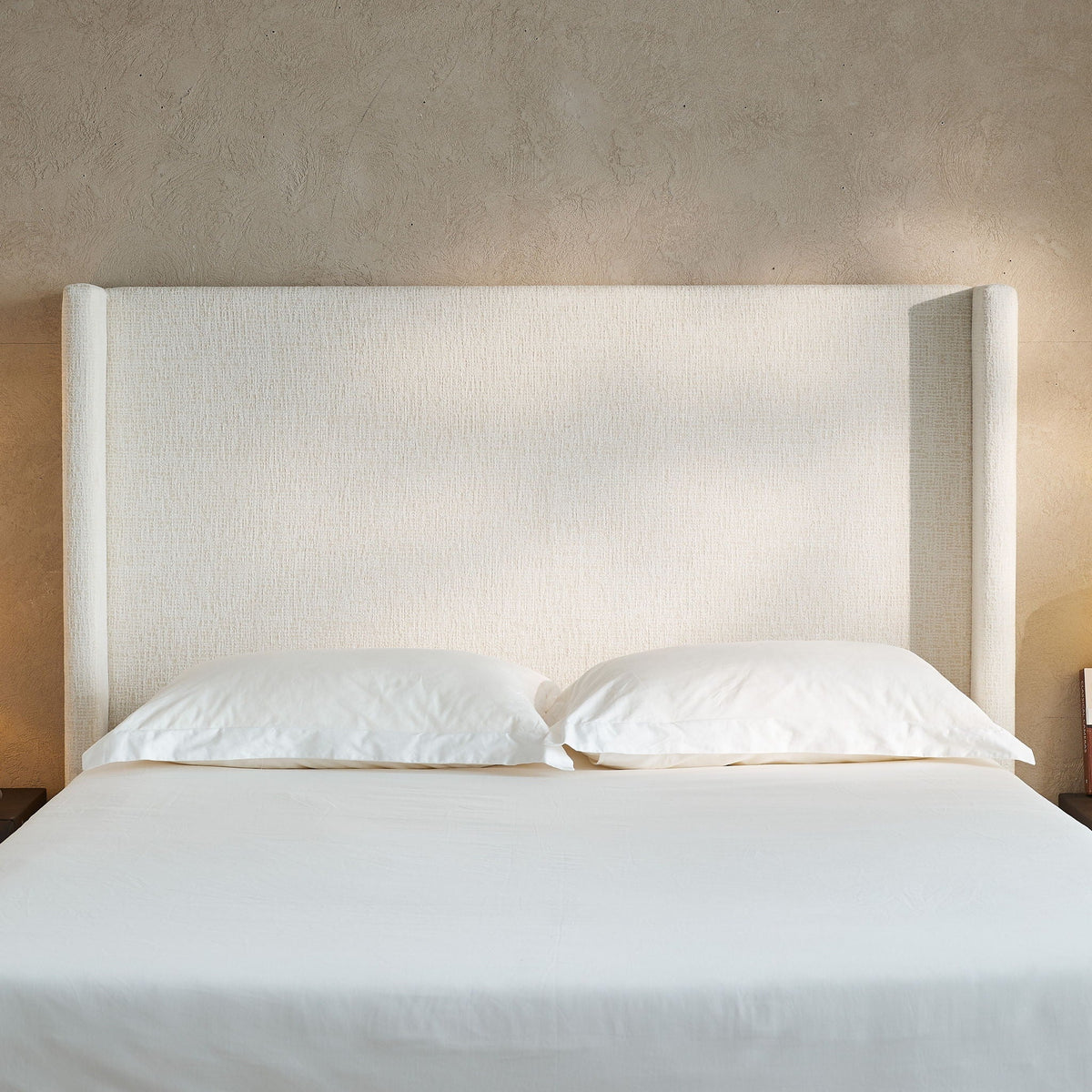 Hosford minimalist upholstered wingback bed with wood base platform in white fabric on Tampa Home & Garden Store