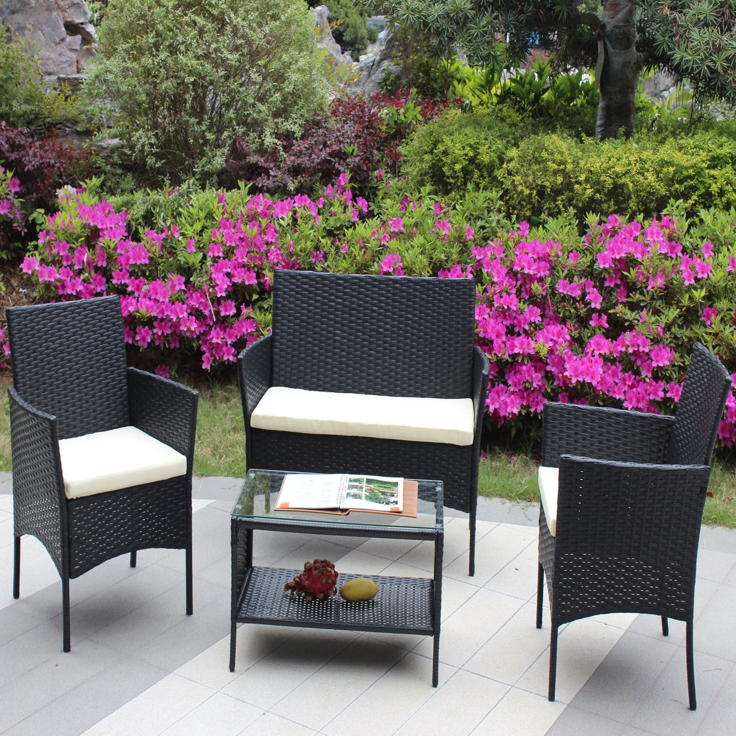 4pc outdoor rattan patio furniture set with cushioned black wicker chairs and glass coffee table on Tampa Home & Garden Store