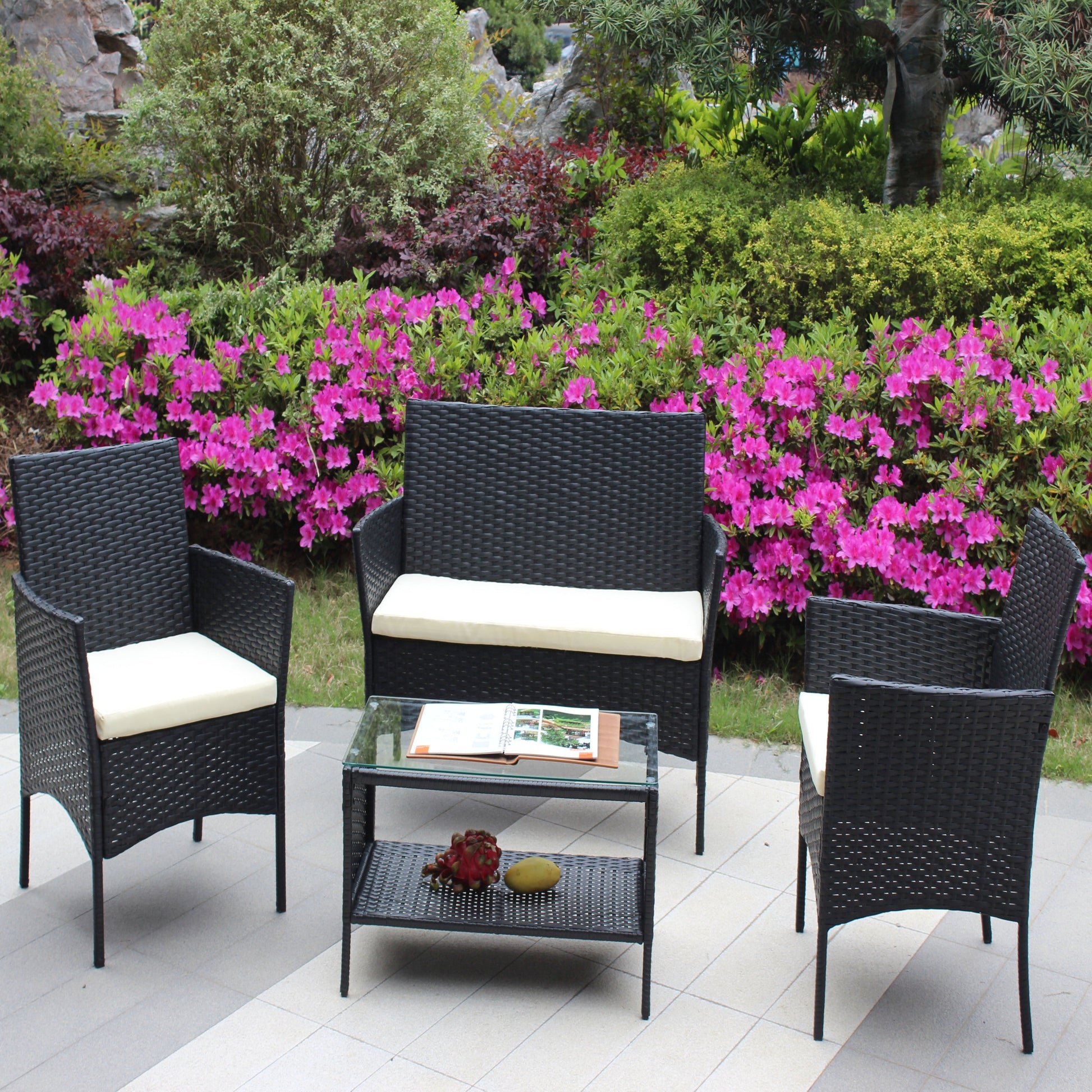 4pc outdoor rattan patio furniture set with cushioned black wicker chairs and glass coffee table on Tampa Home & Garden Store