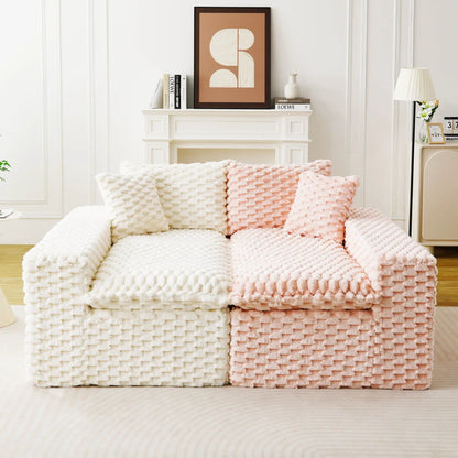 Multifunctional sofa with cream and blush pink chunky knit blankets in a bright living room with a white mantel on Tampa Home & Garden Store