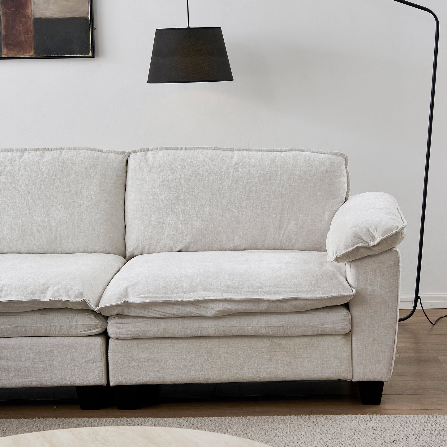 Stationary sofa in soft beige chenille upholstery with plush cushions on Tampa Home & Garden Store