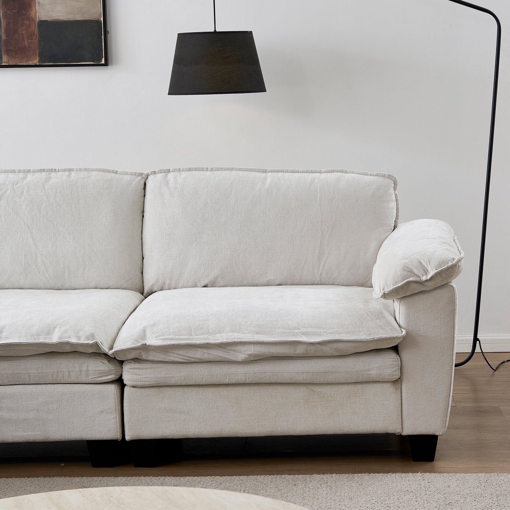 Stationary sofa in soft beige chenille upholstery with plush cushions on Tampa Home & Garden Store