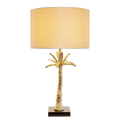 Gold leaf palm table lamp with beige drum shade and dark square base on Tampa Home & Garden Store
