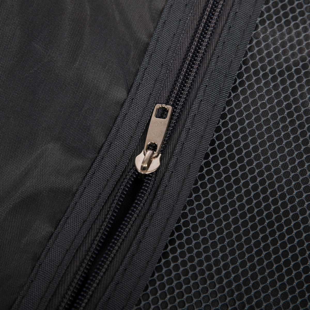 Luggage set zipper close-up on dark fabric with mesh panel from beige ABS spinner wheel luggage set on Tampa Home & Garden Store