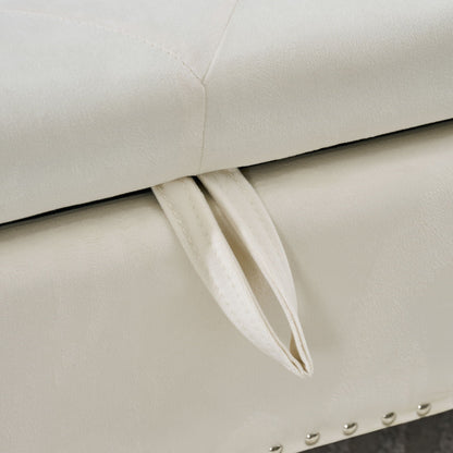 Storage bench upholstered in cream fabric with tufted lid and metal studded trim on Tampa Home & Garden Store