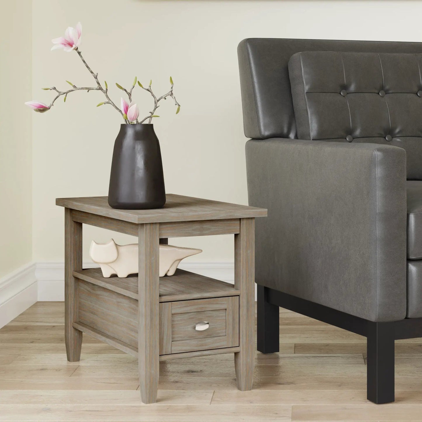 Warm Shaker coffee table in gray wood with dark vase and magnolia branches beside a sofa on Tampa Home & Garden Store