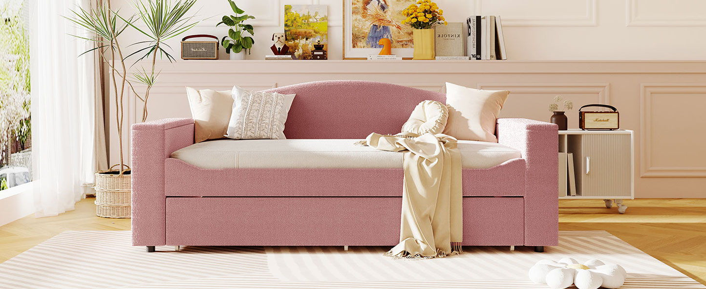 Upholstered pink daybed with storage armrests, beige throw blanket and white pillows on Tampa Home & Garden Store