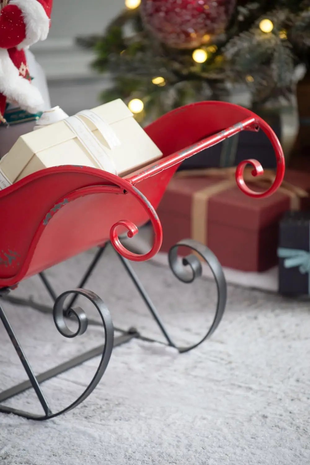 Iron Sleigh Large red distressed Santa sleigh with cream gift box Unique Piece Furniture on Tampa Home & Garden Store