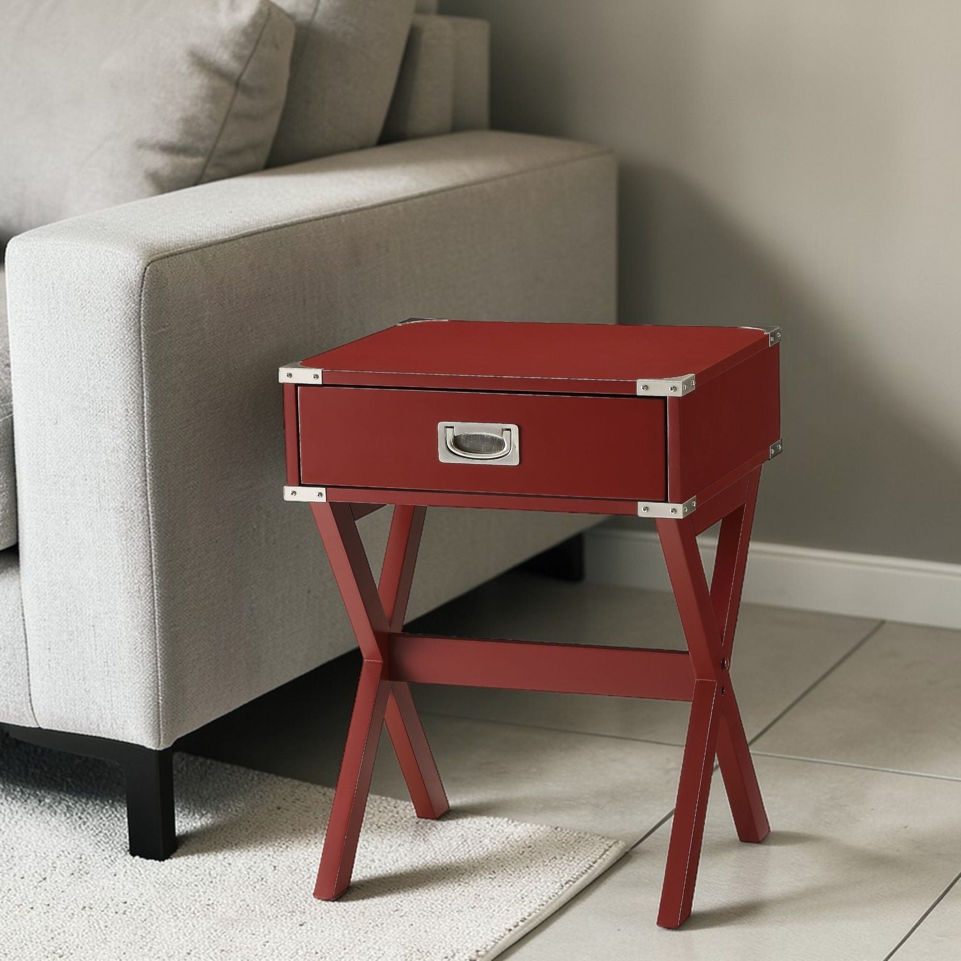 Red Babs accent table with metal corner brackets and angular legs beside a beige sofa on Tampa Home & Garden Store