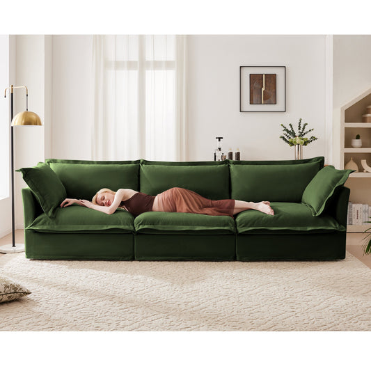 Modern slipcovered 3-seater sofa in deep green chenille with plush cushions, woman resting on it on Tampa Home & Garden Store