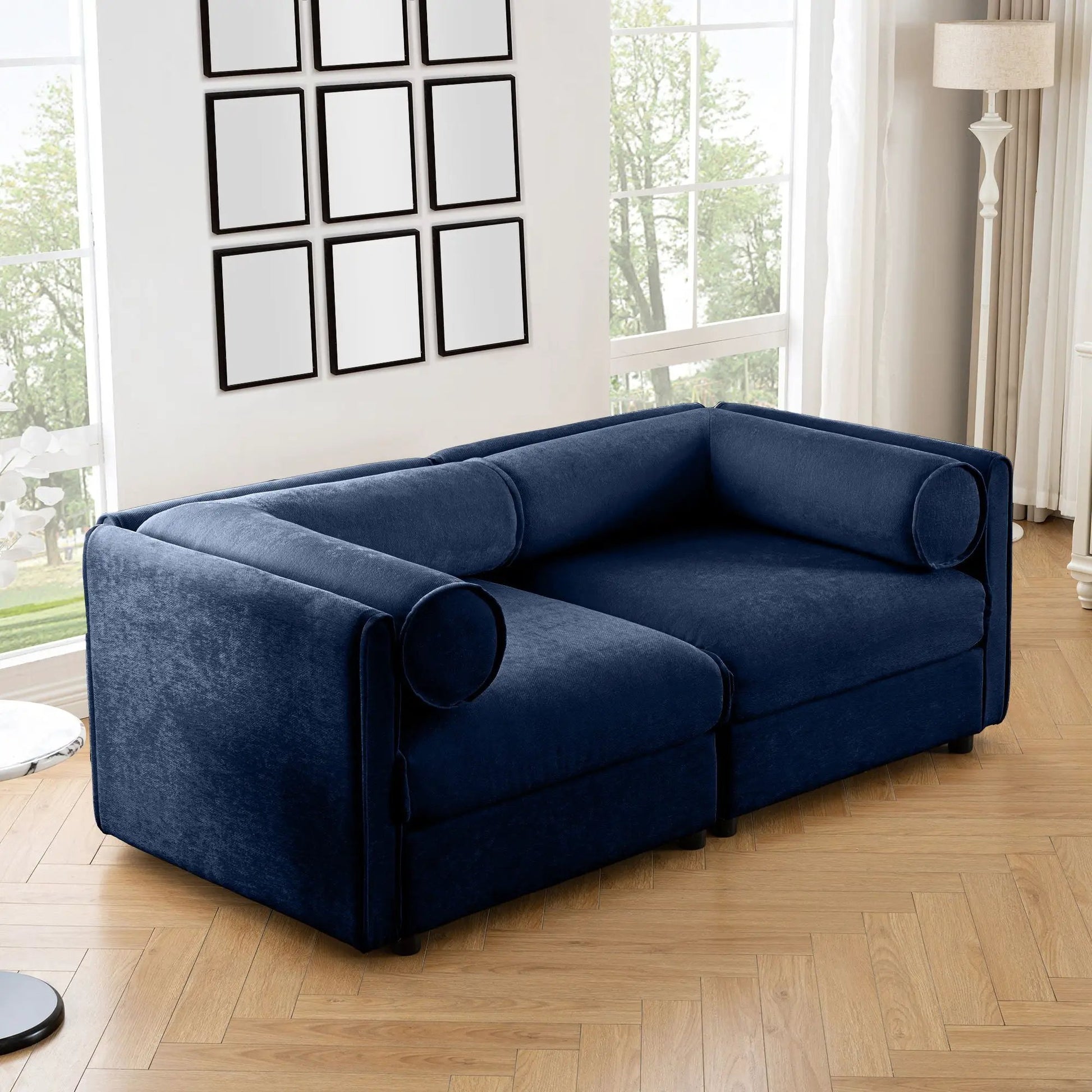 Stationary blue velvet sofa with storage seat and cylindrical backrests in a living room on Tampa Home & Garden Store