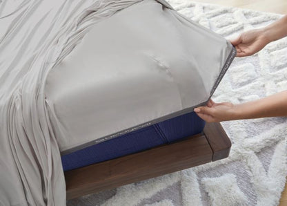 BedGear Vertex split Cal King sheet set in light grey atop a blue mattress on a wood frame on Tampa Home & Garden Store