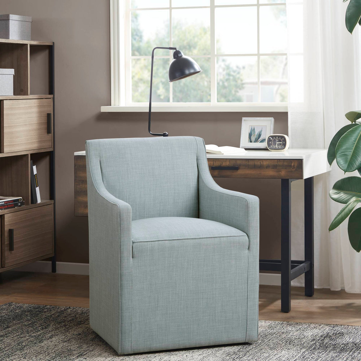 Traditional skirted dining arm chair in light blue upholstery with hidden casters on Tampa Home & Garden Store