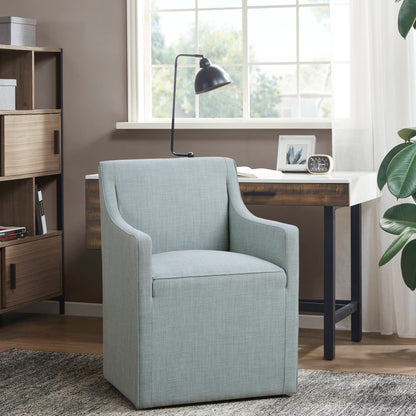 Traditional skirted dining arm chair in light blue upholstery with hidden casters on Tampa Home & Garden Store