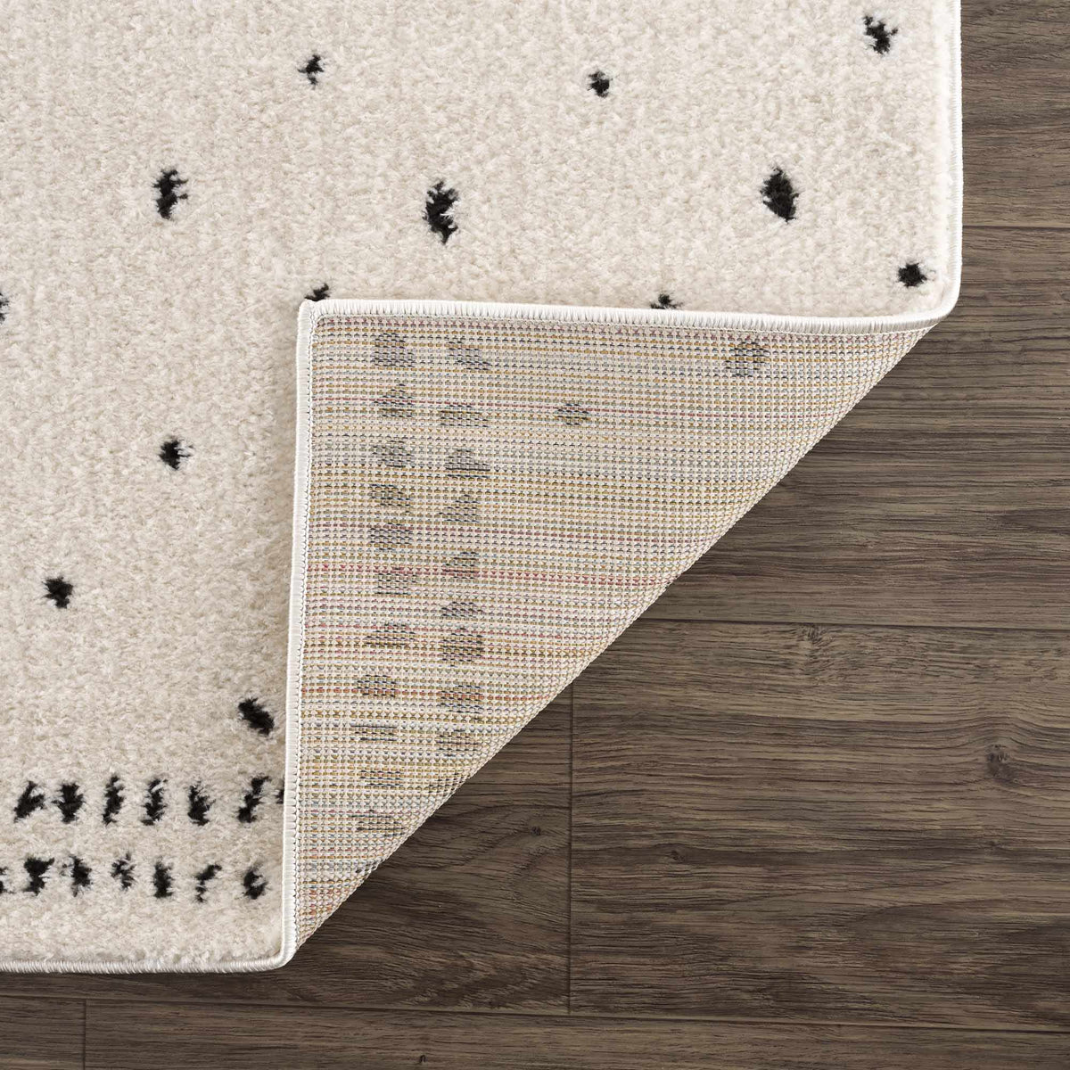 Julie Area Rug by Boutique Rugs, cream beige pile with small black diamond motifs on Tampa Home & Garden Store