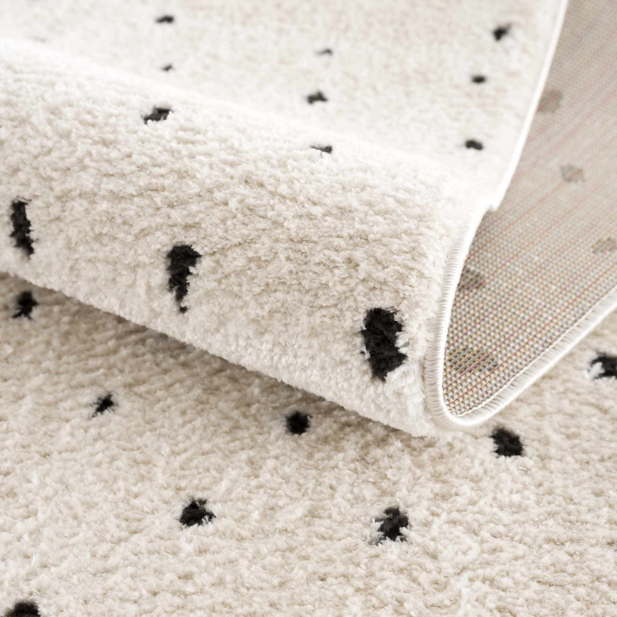 Julie area rug by Boutique Rugs, ivory shag with black speckles, plush texture on Tampa Home & Garden Store