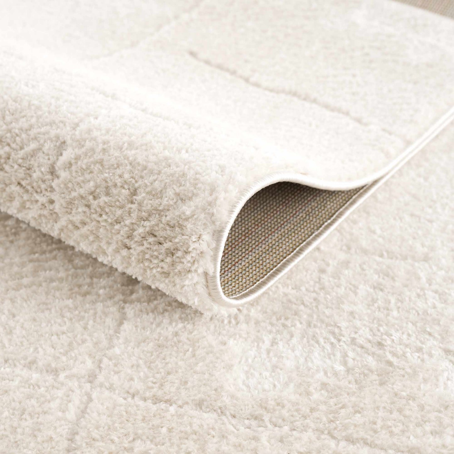 Koume Ivory Area Rug plush ivory pile with a rolled edge on Tampa Home & Garden Store