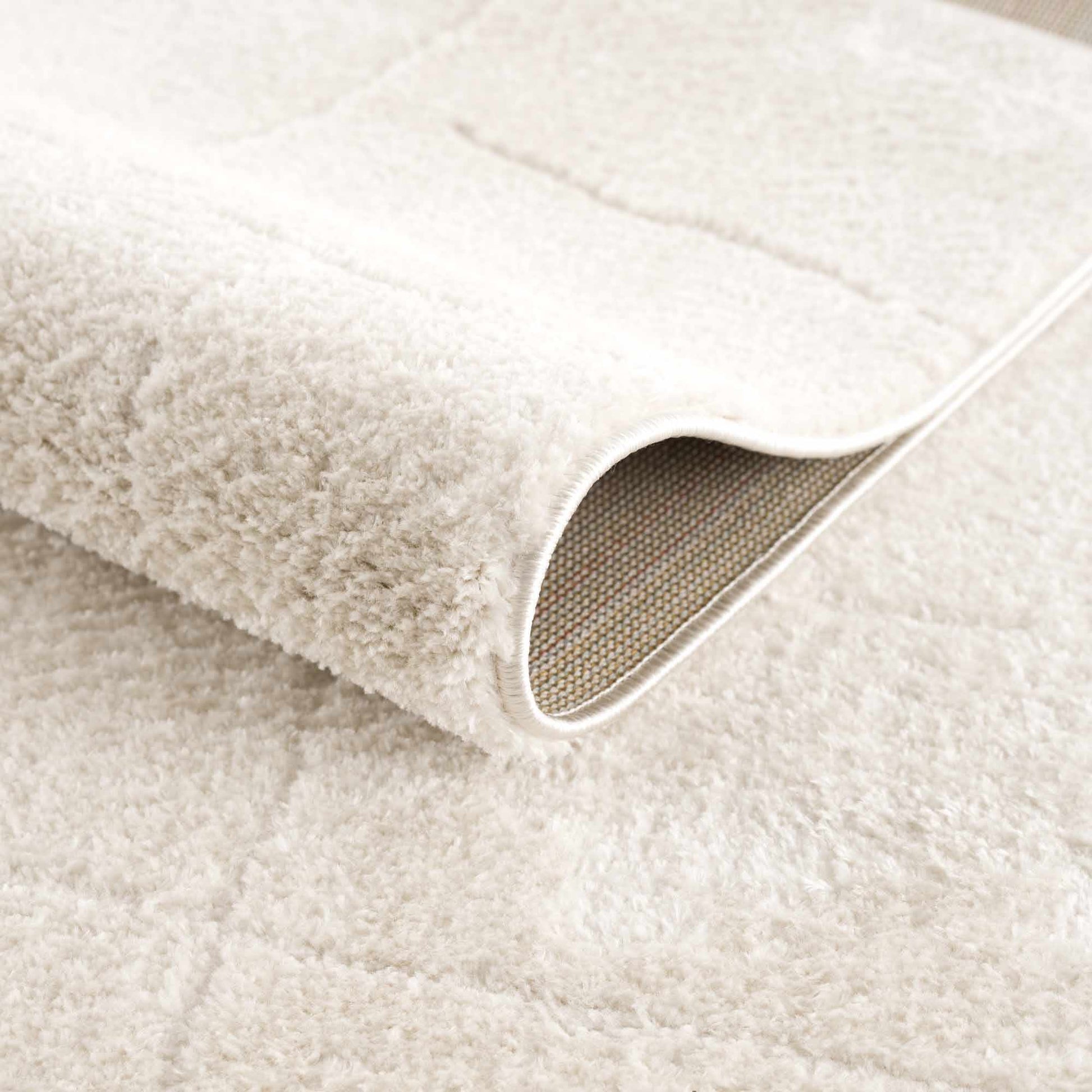 Koume Ivory Area Rug plush ivory pile with a rolled edge on Tampa Home & Garden Store