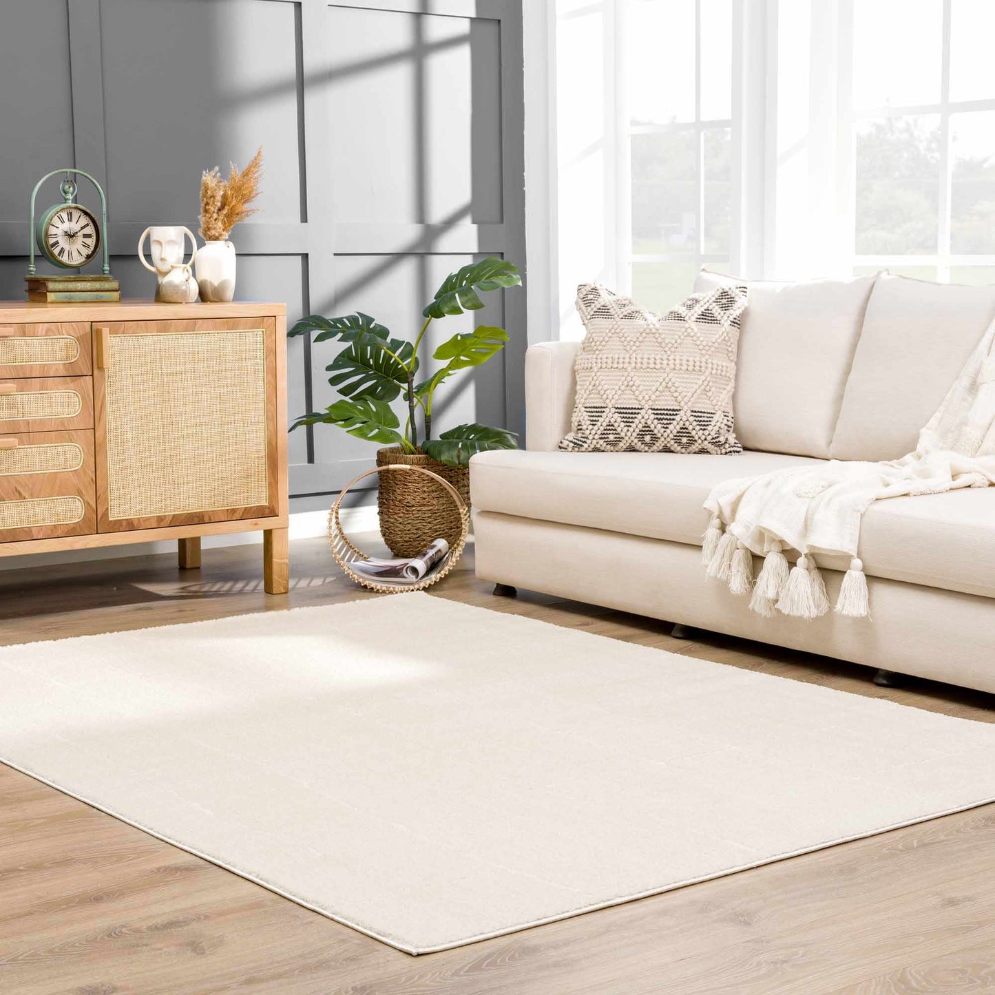 Koume Ivory Area Rug by Boutique Rugs in a bright living room with a cream sofa and natural decor on Tampa Home & Garden Store