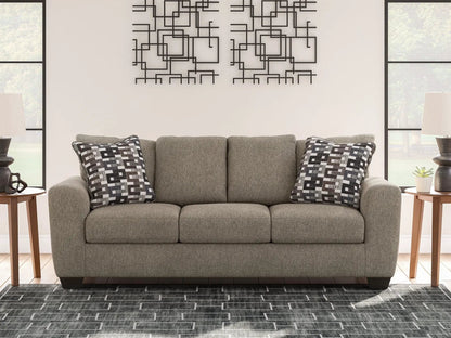 Triston-Peaks suede stationary sofa in gray upholstery with two geometric throw pillows on Tampa Home & Garden Store