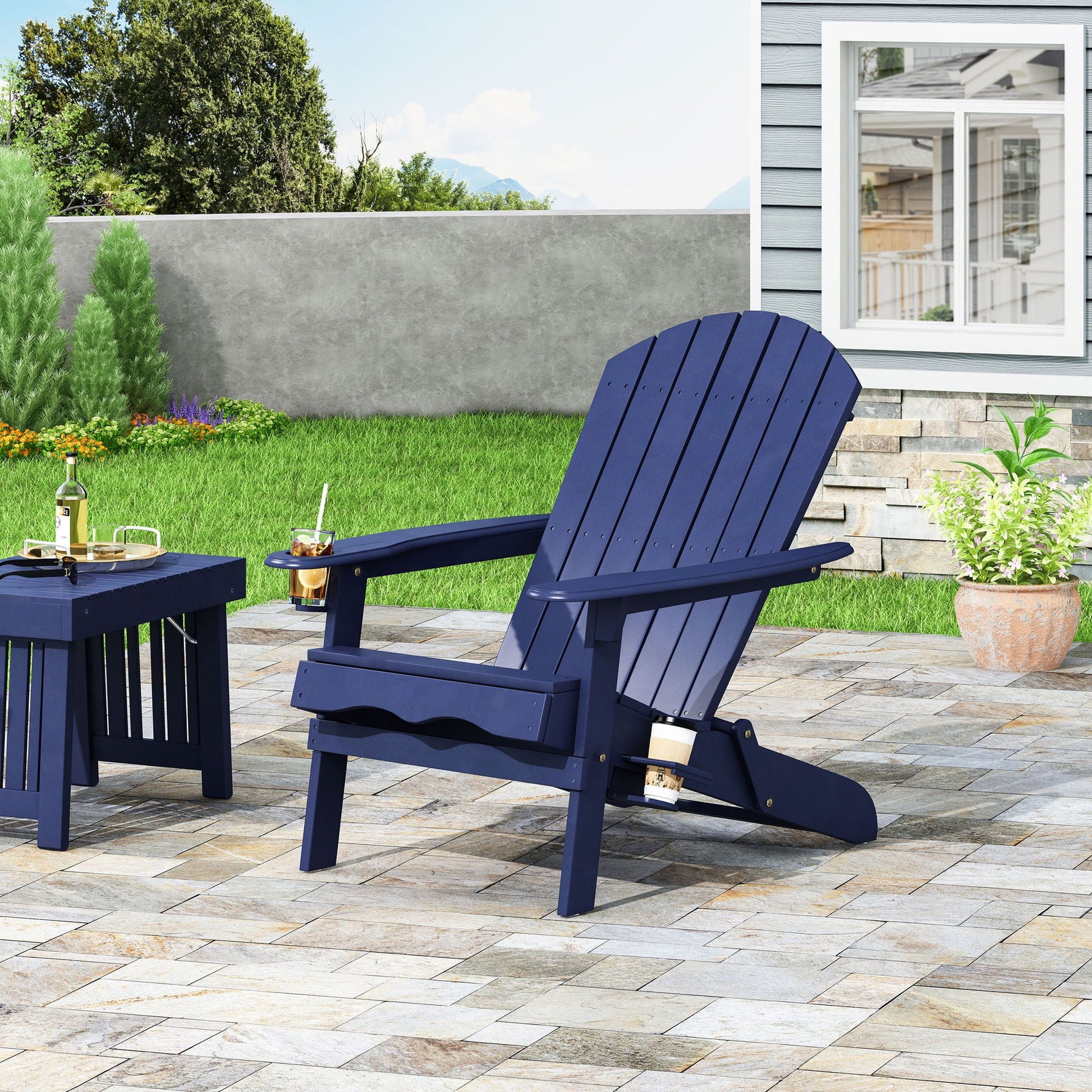 Zenithia outdoor foldable Adirondack chairs in navy blue with 2 cup holders on a patio on Tampa Home & Garden Store