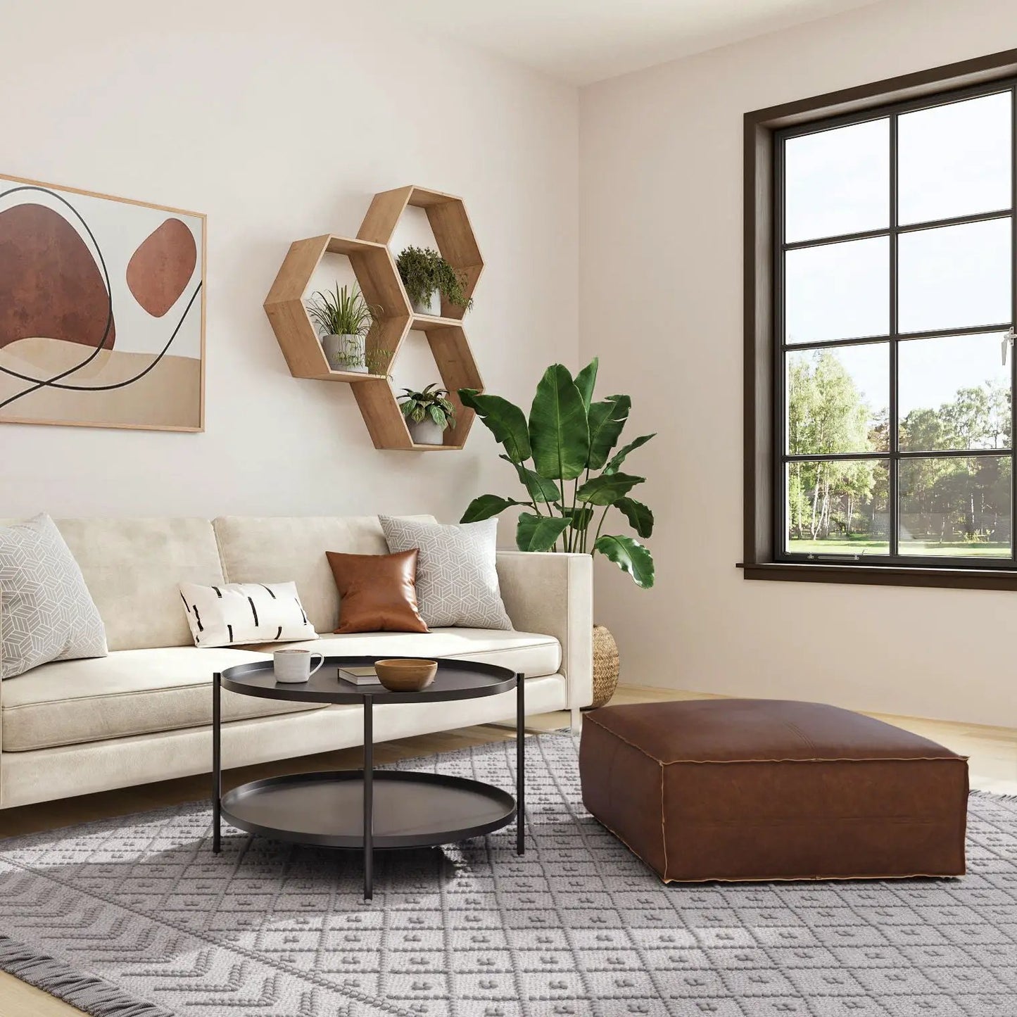 Brody large square coffee table pouf in brown leather beside beige sofa in a modern living room on Tampa Home & Garden Store