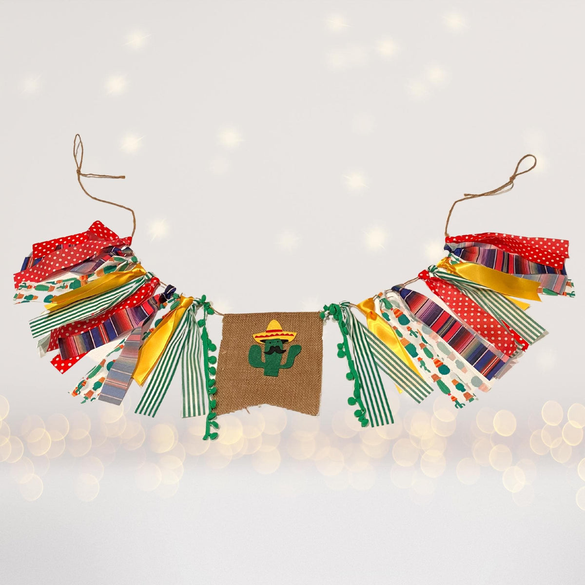 Fiesta banner with colorful paper tassels and a burlap center panel featuring cactus on Tampa Home & Garden Store