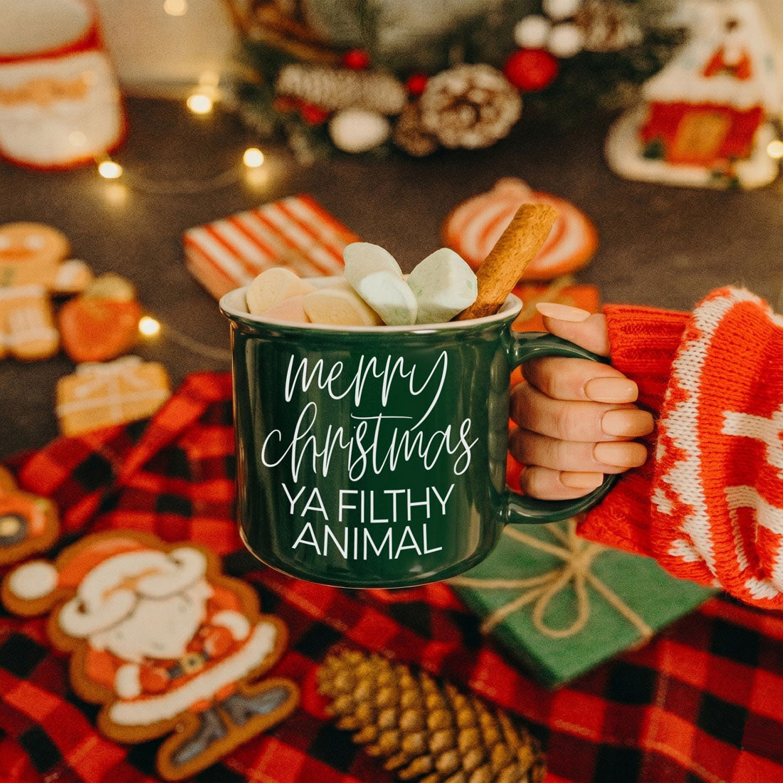 Ya Filthy Animal mug filled with marshmallows and a cinnamon stick held by a hand on Tampa Home & Garden Store