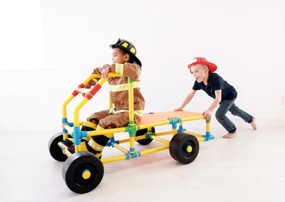 TubeLox Deluxe Set STEM toy two kids push a colorful yellow blue red wheeled tube frame on Tampa Home & Garden Store