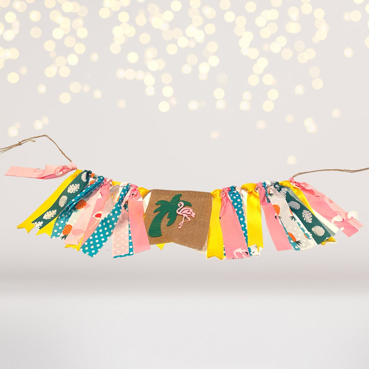 Flamingo Ribbon Banner with colorful tassels and tropical flamingo palm motifs for pineapple high chair decor on Tampa Home & Garden Store