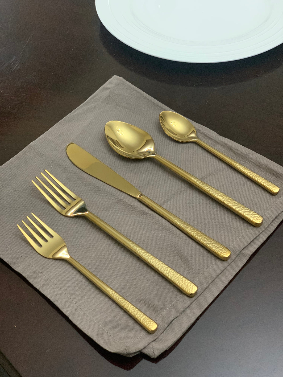 Vibhsa 20 Piece Gold Flatware Set for 4, shiny hammered gold finish with textured handles on Tampa Home & Garden Store