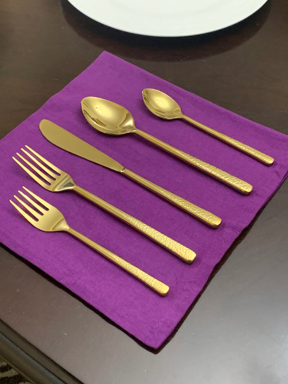 Vibhsa gold 20-piece flatware set for 4 displayed on a purple napkin on Tampa Home & Garden Store
