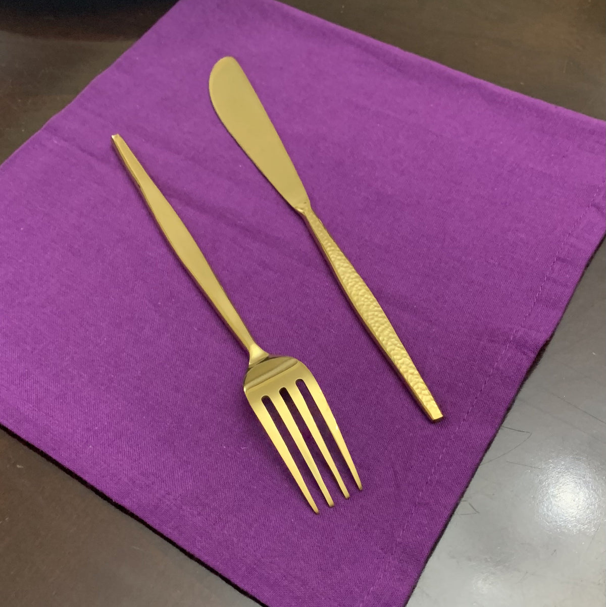 Vibhsa gold hammered flatware fork and knife on purple napkin on Tampa Home & Garden Store