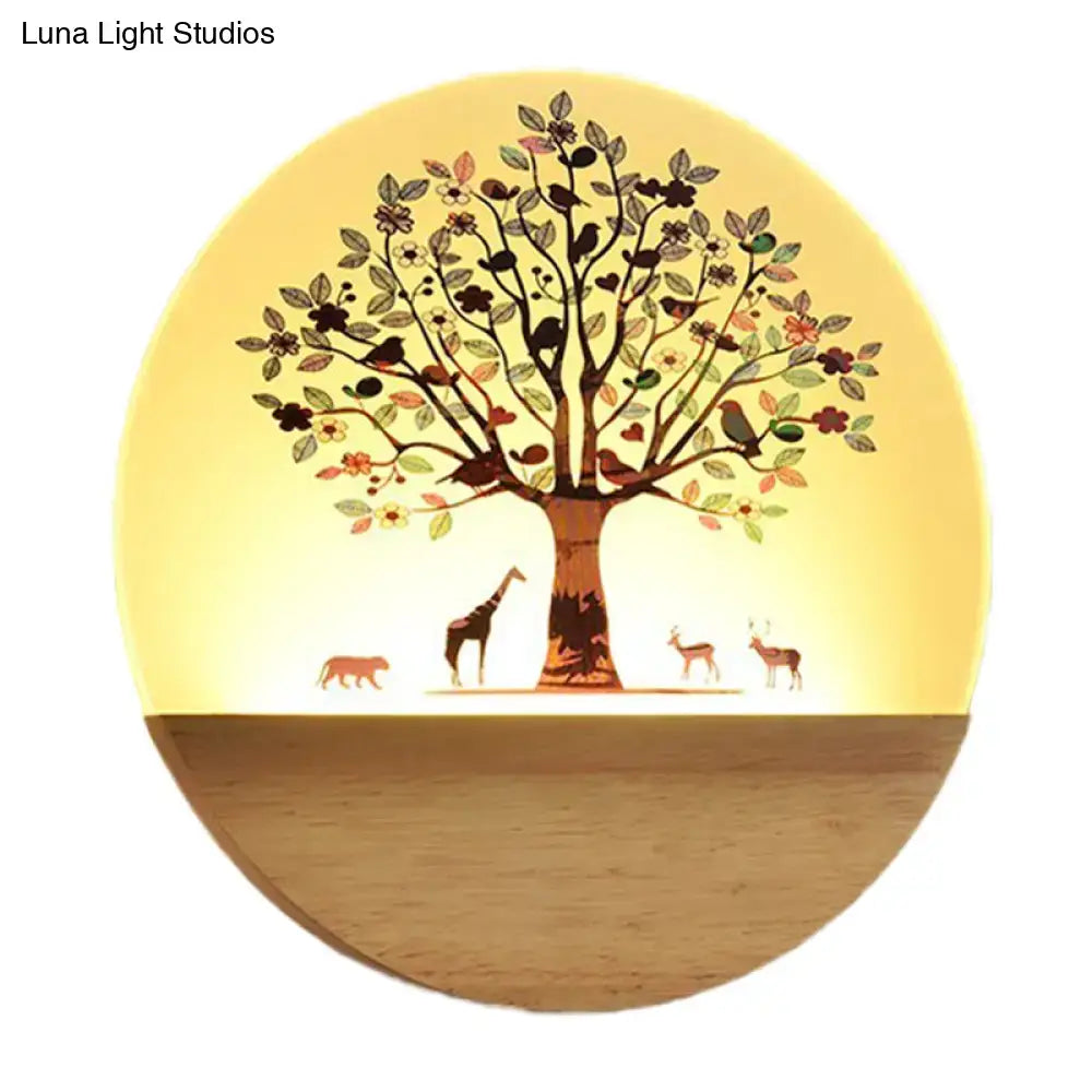 Modern wood wall light with warm yellow shade, tree silhouette and woodland animals on wood base on Tampa Home & Garden Store