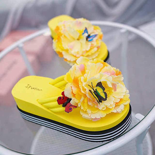 Stevvex pair of yellow flower platform slippers for women with large petals and butterfly accents on Tampa Home & Garden Store