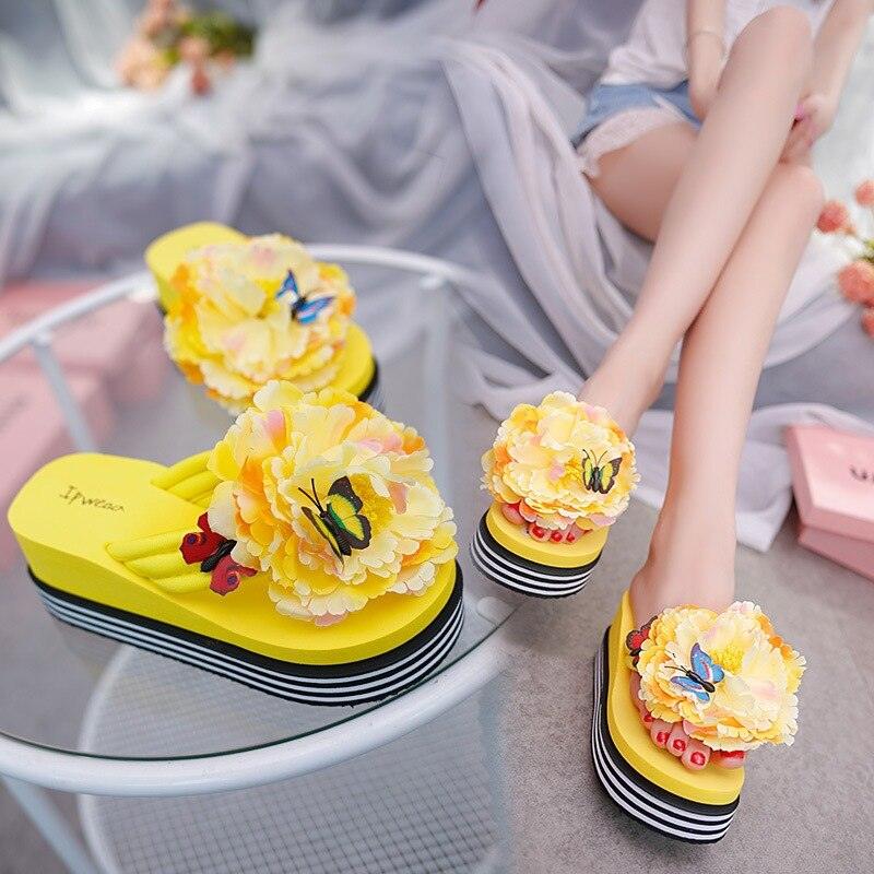 Stevvex yellow flower platform slippers with floral pom-poms and butterfly accents, 2 pairs shown on Tampa Home & Garden Store