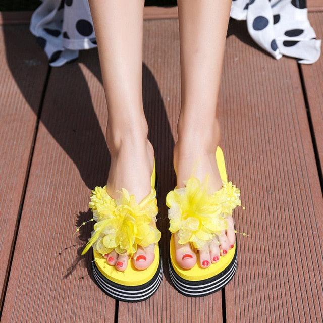 Stevvex yellow floral platform flip flops pair with large flower embellishments and striped sole on Tampa Home & Garden Store