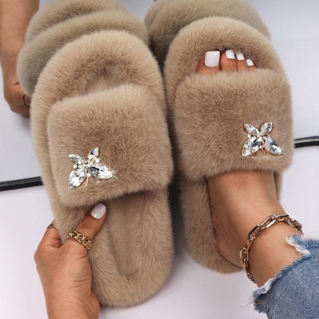 Stevvex women faux fur slippers; pair of beige fluffy mules with rhinestone butterfly accents on Tampa Home & Garden Store
