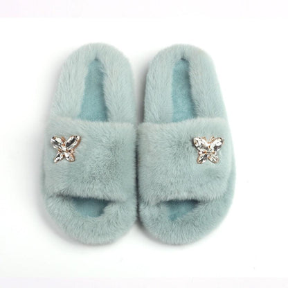 Women Stevvex faux fur slippers pair with rhinestone butterfly accents in light blue on Tampa Home & Garden Store
