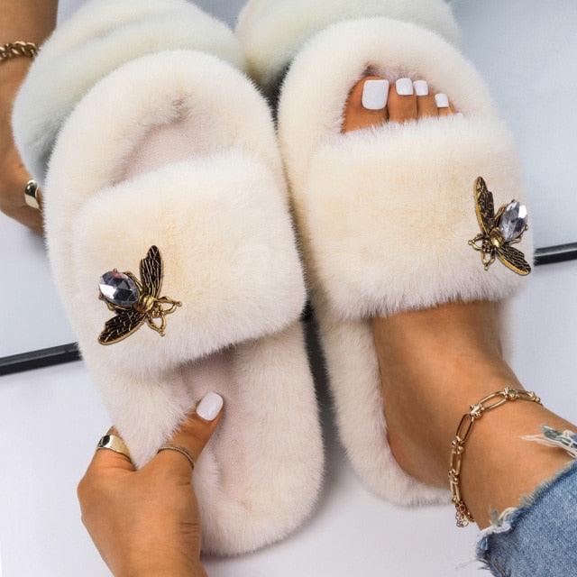 Stevvex women faux fur slippers with rhinestone butterfly accents, cream color, pair on Tampa Home & Garden Store