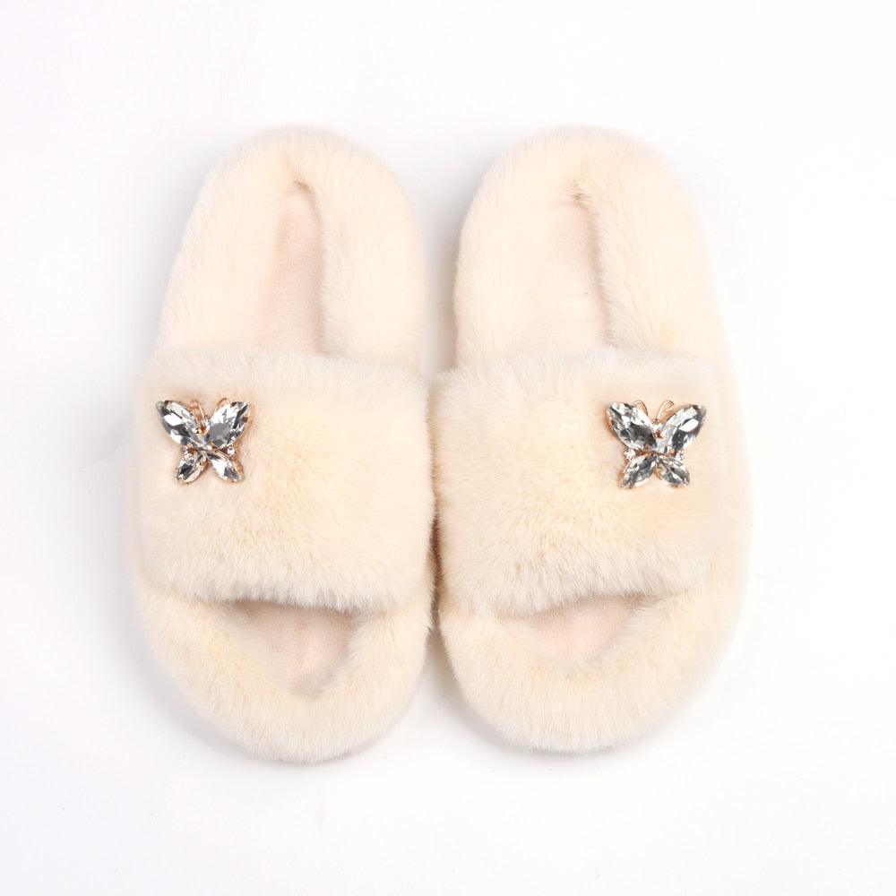 Women Stevvex faux fur slippers, beige with rhinestone butterfly accents, pair on Tampa Home & Garden Store