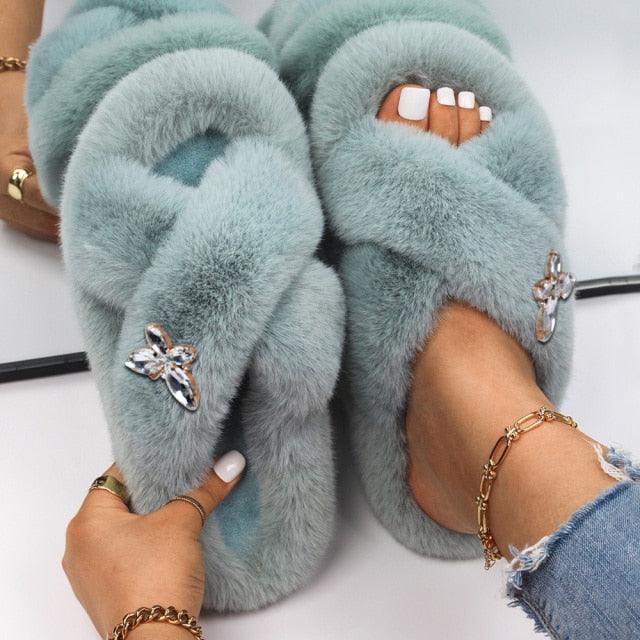 Women’s faux fur slippers with rhinestone butterfly accents, light teal pair by Stevvex on Tampa Home & Garden Store