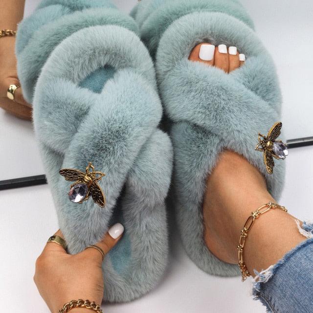 Stevvex women's faux fur slippers, light blue pair with rhinestone butterfly accents on Tampa Home & Garden Store