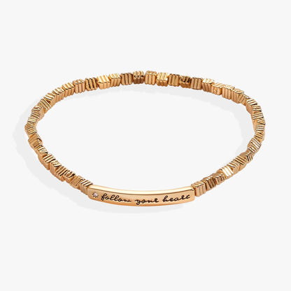 Gold-tone Alex and Ani Follow Your Heart stretch bracelet with engraved script plate on Tampa Home & Garden Store