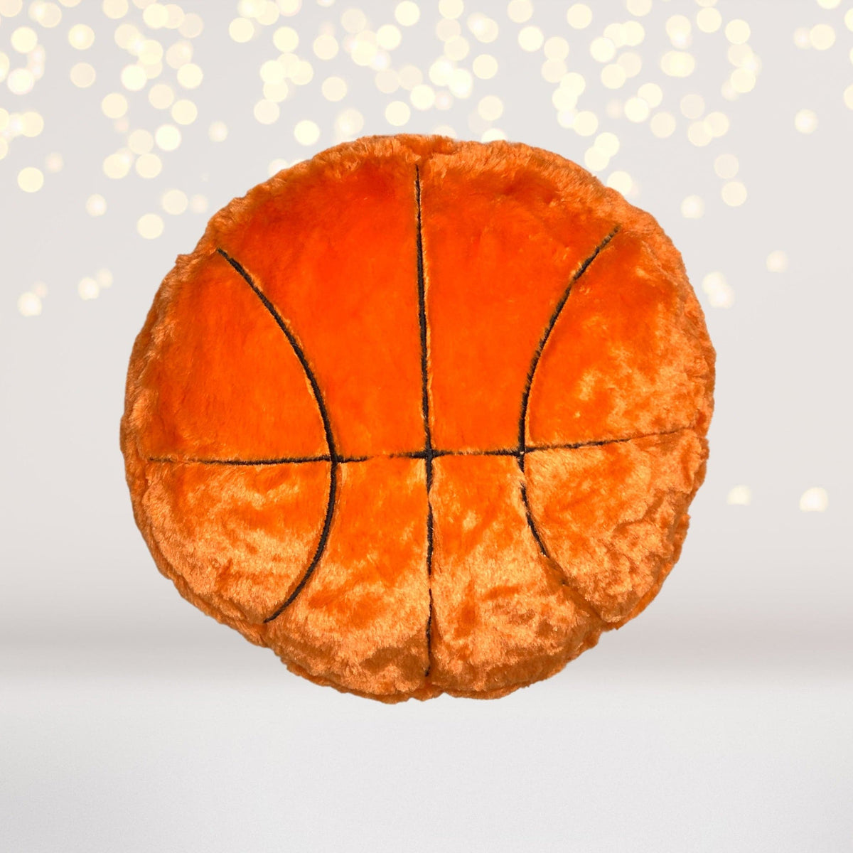 Basketball-style plush throw pillow in bright orange with black seam lines on Tampa Home & Garden Store