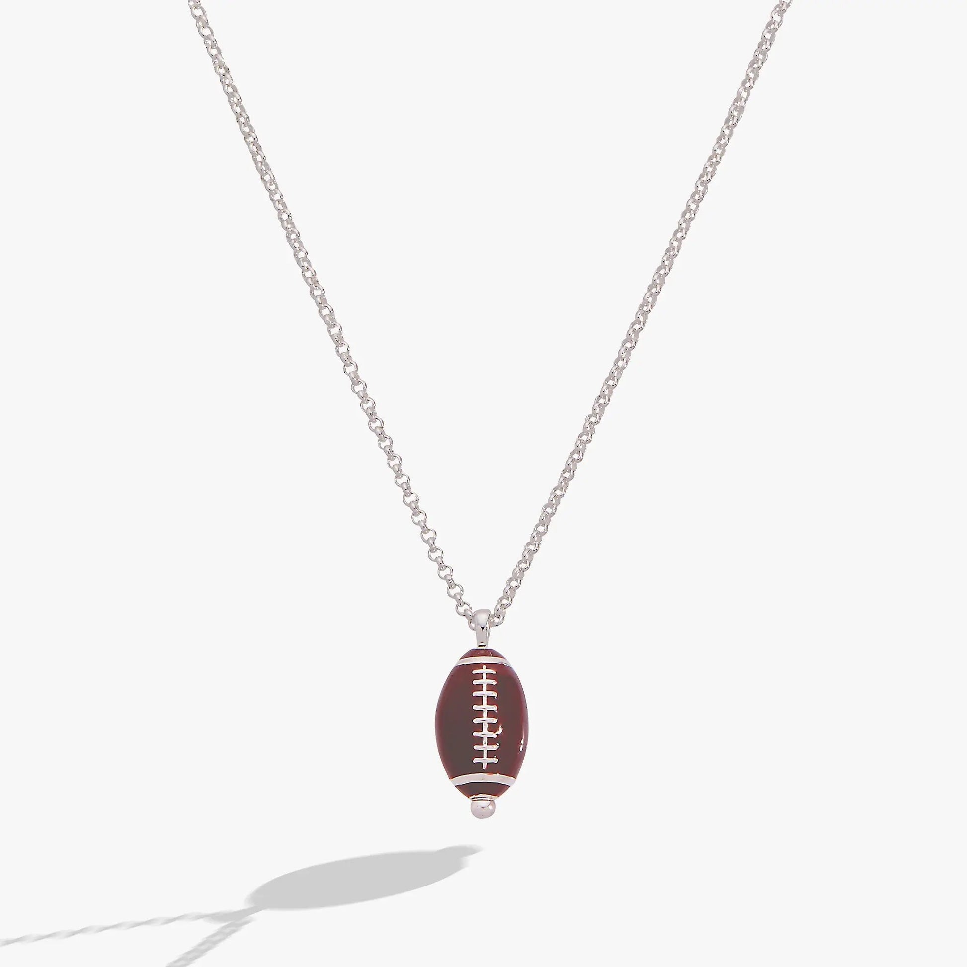 Football Spinner Pendant Necklace with brown football charm and white laces on silver chain on Tampa Home & Garden Store