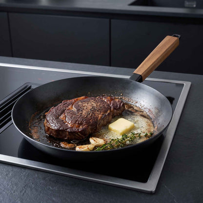 Carbon Steel Frying Pan Alva Cookware with wooden handle cooking steak in butter and herbs on Tampa Home & Garden Store