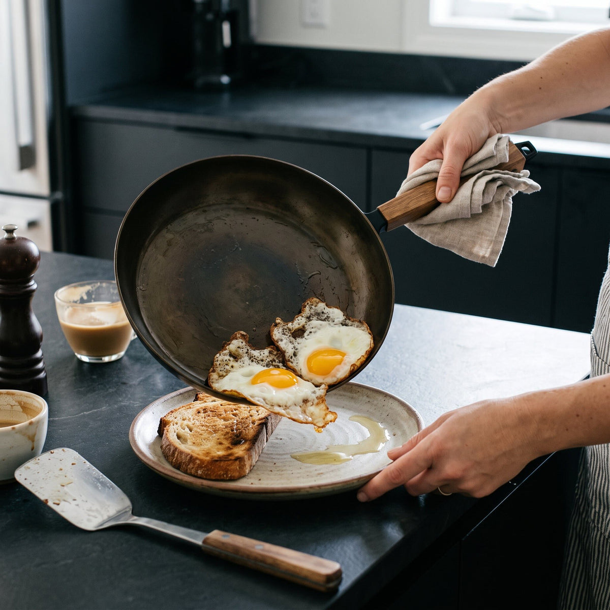 Alva Cookware carbon steel frying pan with wooden handle holding sunny-side-up eggs and toast on Tampa Home & Garden Store